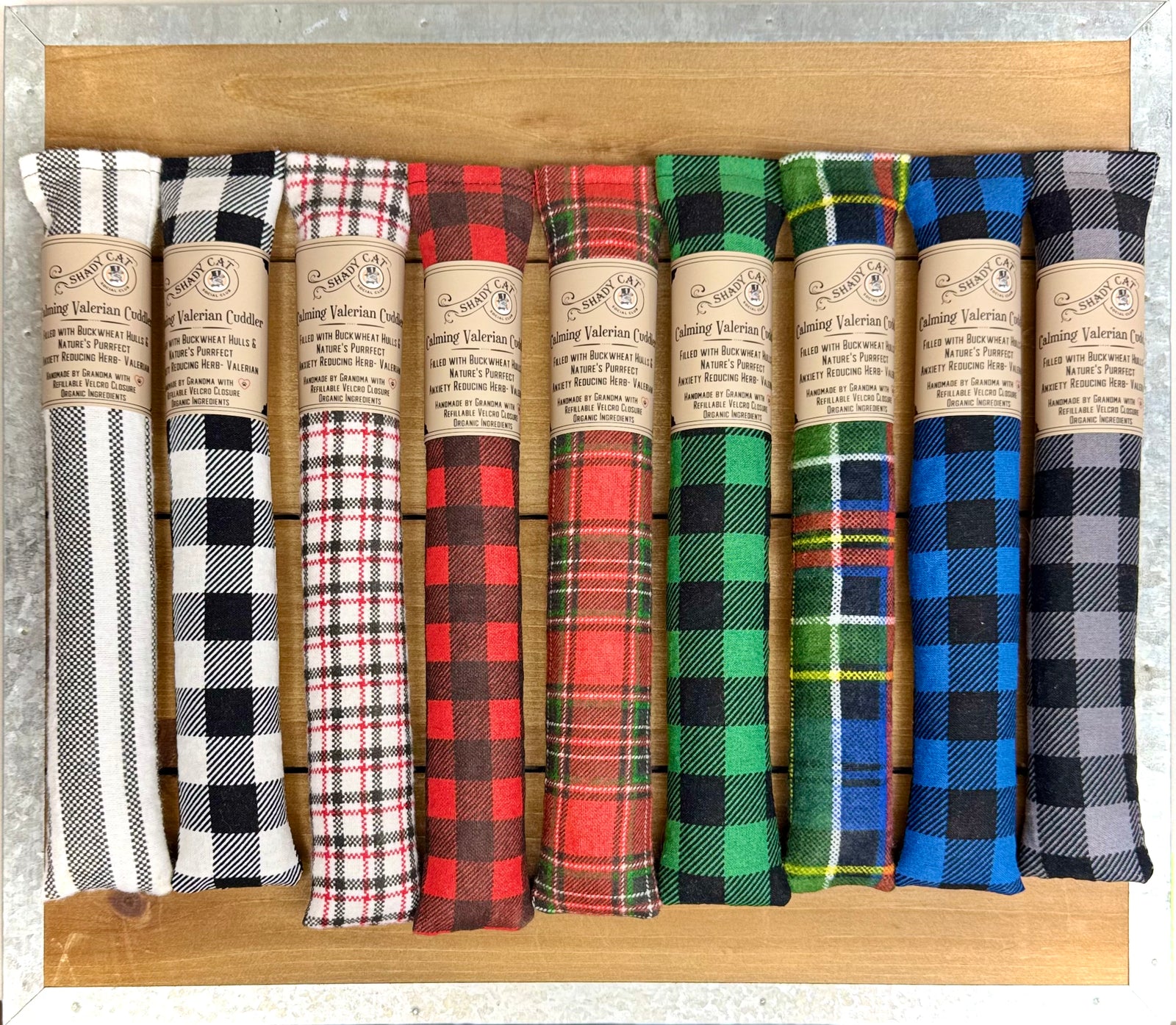 Variety of plaid cat toys from Shady Cat Social Club filled with calming Valerian Root called Calming Cuddlers